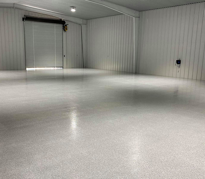 This decorative flake epoxy floor, installed by J&A Services, is very durable and a great floor choice for high traffic industrial areas like this warehouse building.