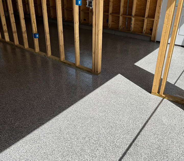 This decorative flake epoxy floor in Alabama is installed by J&A Services and is perfect in a home or residential garage, like pictured here. This flooring was installed during the consturciton of the home.